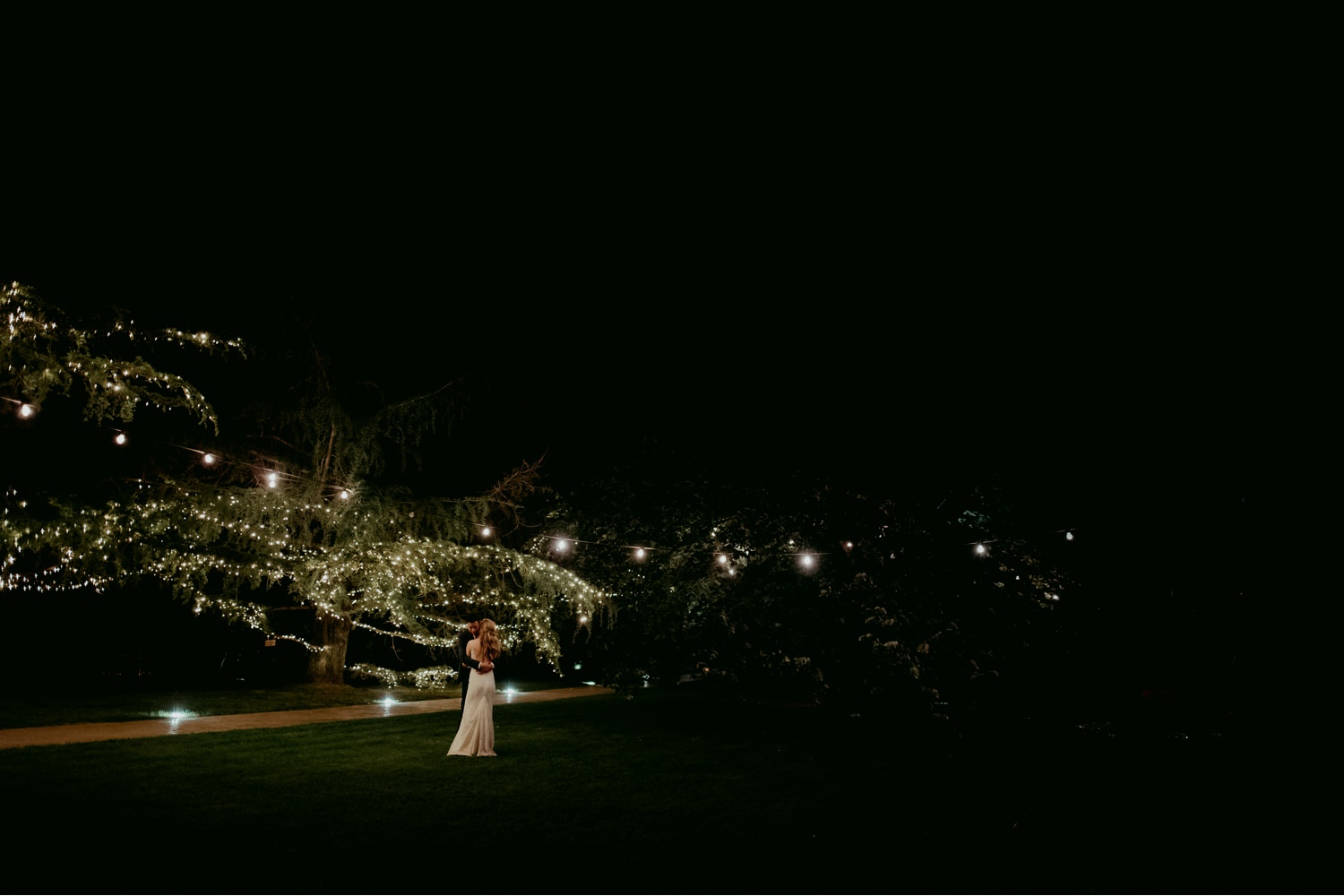 Sitges wedding photographer capturing the bride and groom celebrating under the lights